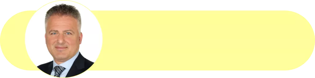 Professionelles Portrait von Ok Ocak, Leiter der Finanzabteilung bei Frenvi, im Business-Outfit vor neutralem Hintergrund.